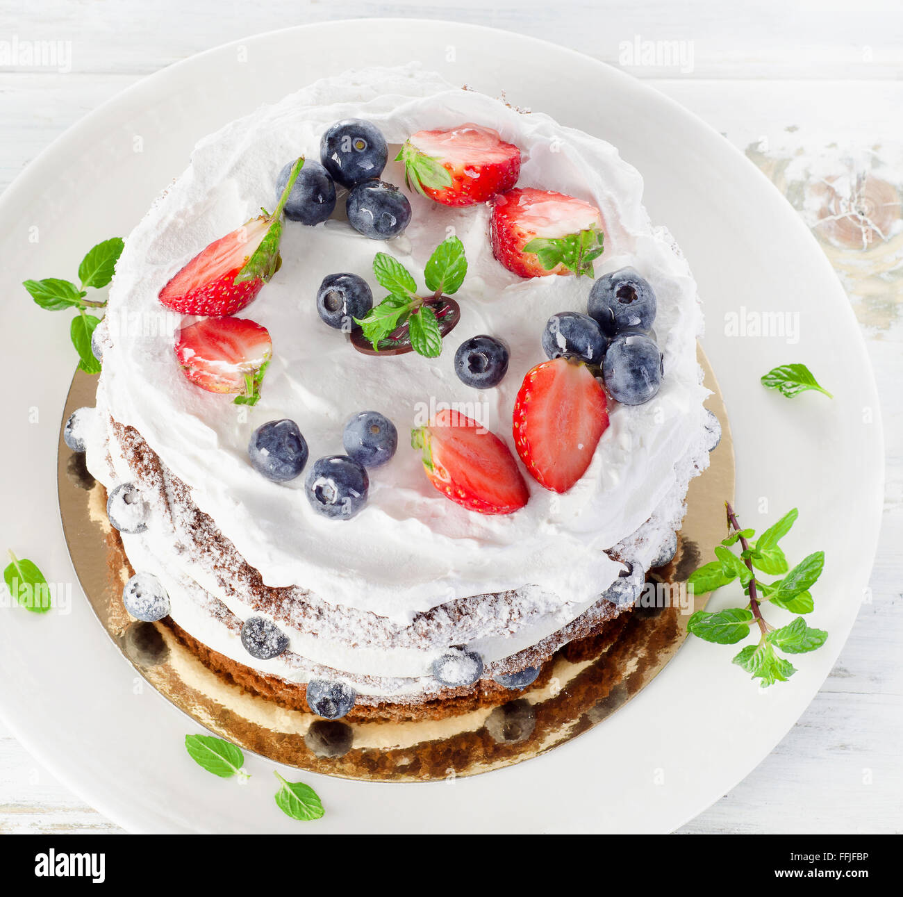 Cake with cream and berries. View from above Stock Photo