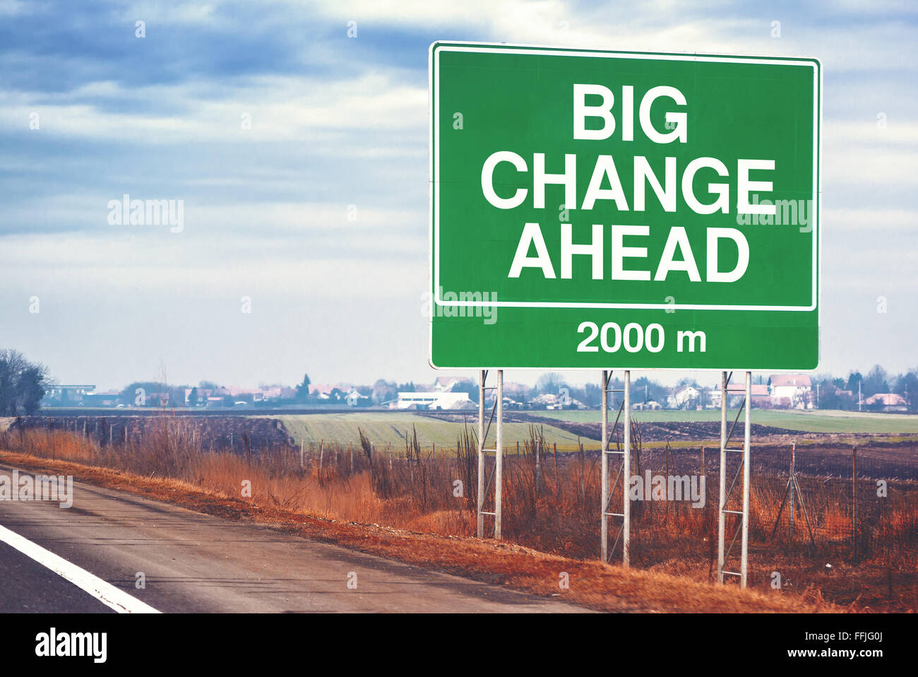 Big change ahead conceptual motivational image with road sign by the highway, retro toned image with selective focus Stock Photo