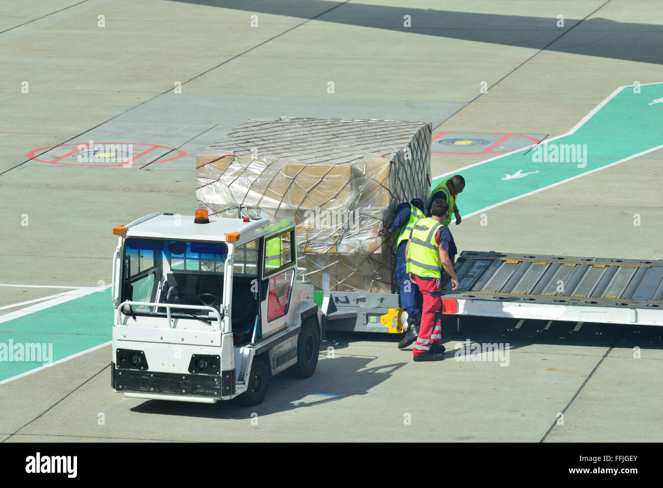 Airport workers loading freight onto a long haul Aircraft at London Gatwick Stock Photo