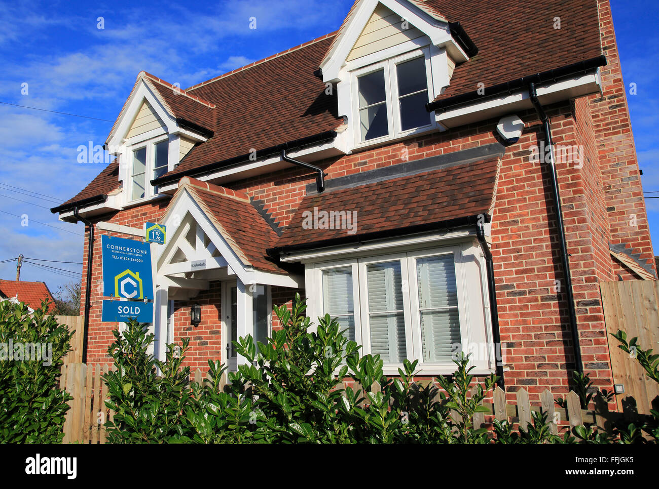 Estate agent sold sign outside modern house, Melton, Suffolk, England