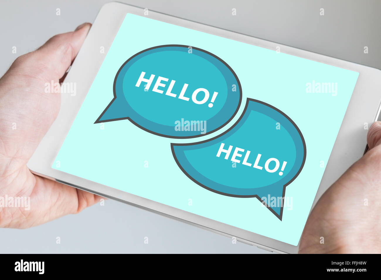 Greetings and business communication concept with speech bubble spelling out hello displayed on modern touch screen device Stock Photo