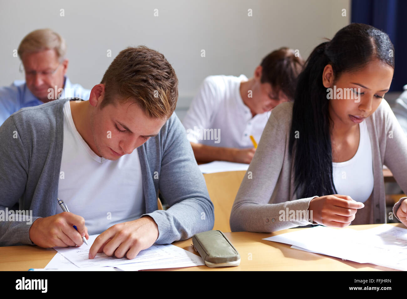 Job candicates taking tests in assessment center Stock Photo