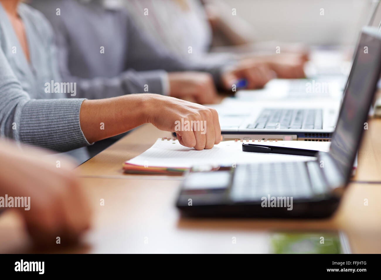 Students knocking on table for approval and applause Stock Photo