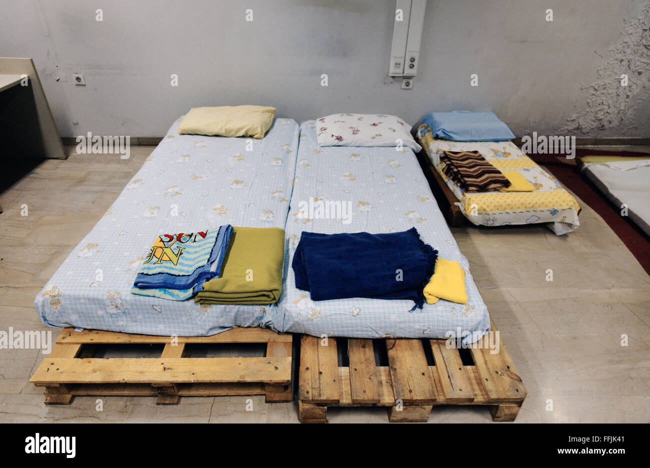 07/10/2015  -  Greece / Athens  -  Two single beds and a smaller matress for a child lay with clean sheets in a room of Notara 2 Stock Photo