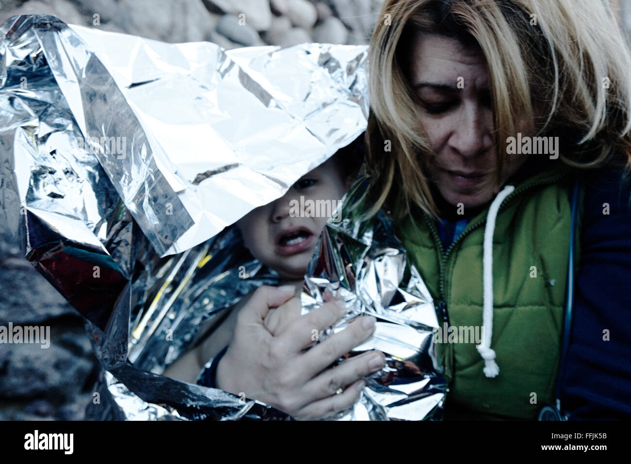 Doctors help refugees after having crossed the 7 miles of distance from Turkish coast to Lesvos. Stock Photo