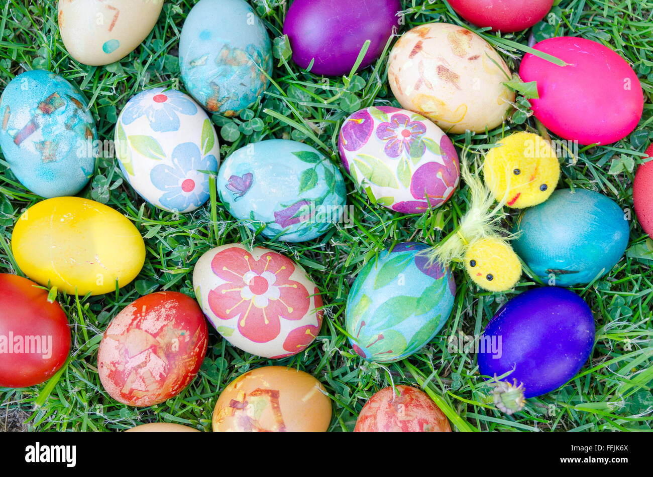 Bunch of decoupage decorated colorful Easter eggs on the grass Stock Photo