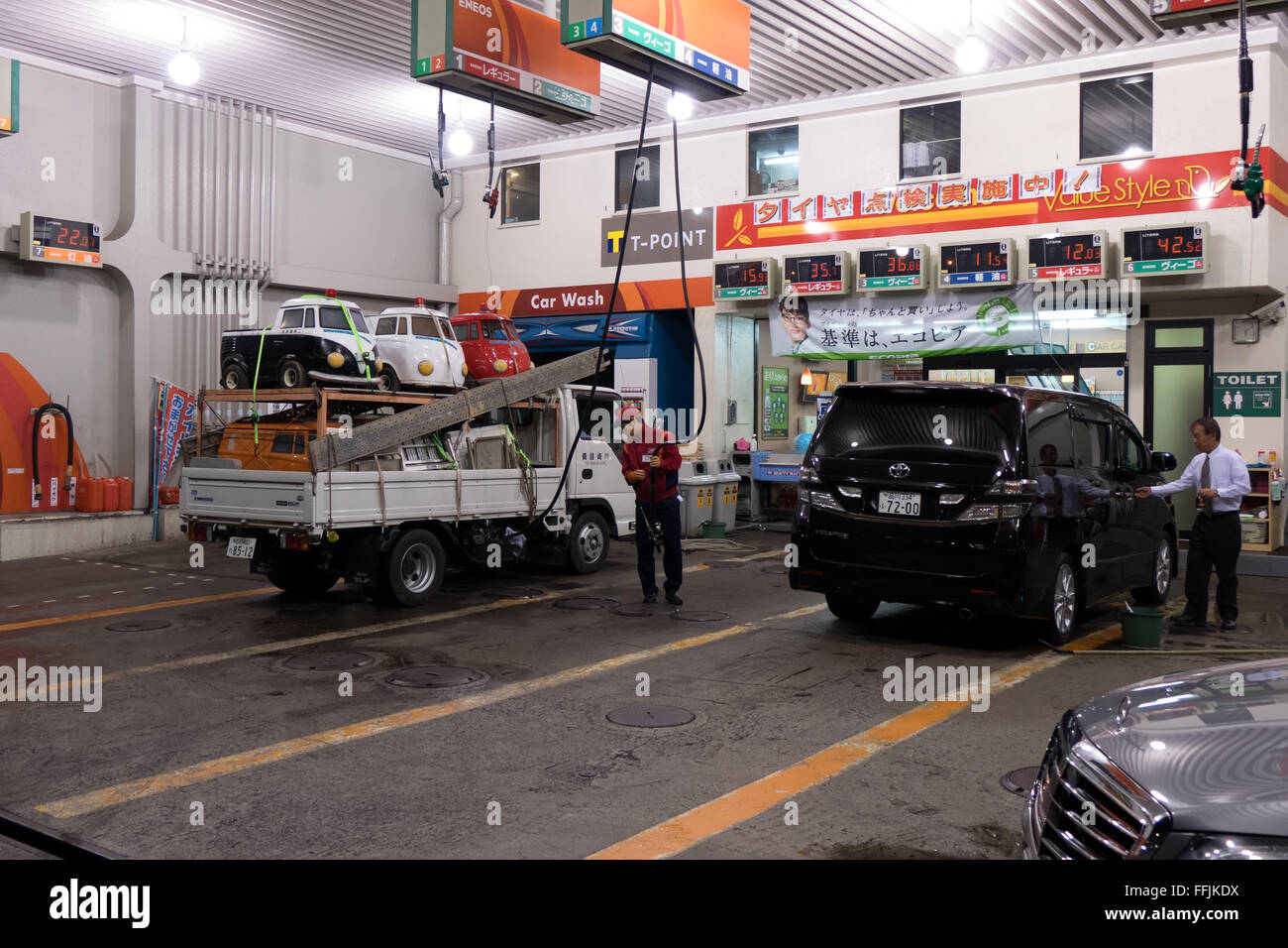 Gas station with man, fuel, cars. Roppongi Hills district, Tokyo, Japan