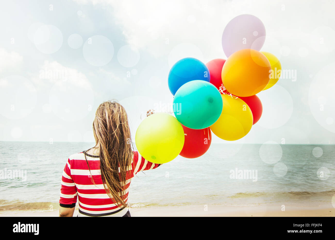 Woman with colorful Balloons on the beach,Outdoors lifestyle filters image Stock Photo