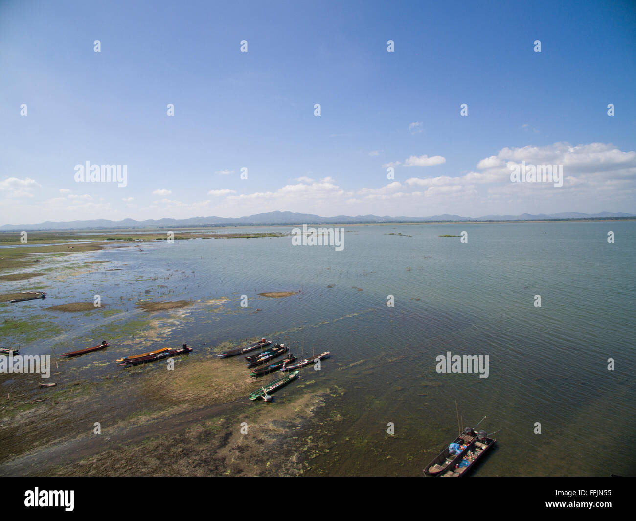 Lamtakong lake shore with boats and blue sky, Lamtakong dam, Nakornratchima, Thailand Stock Photo