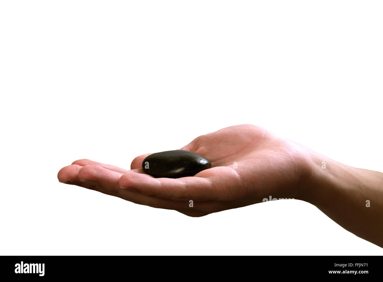 hand holding meditative black stone Stock Photo