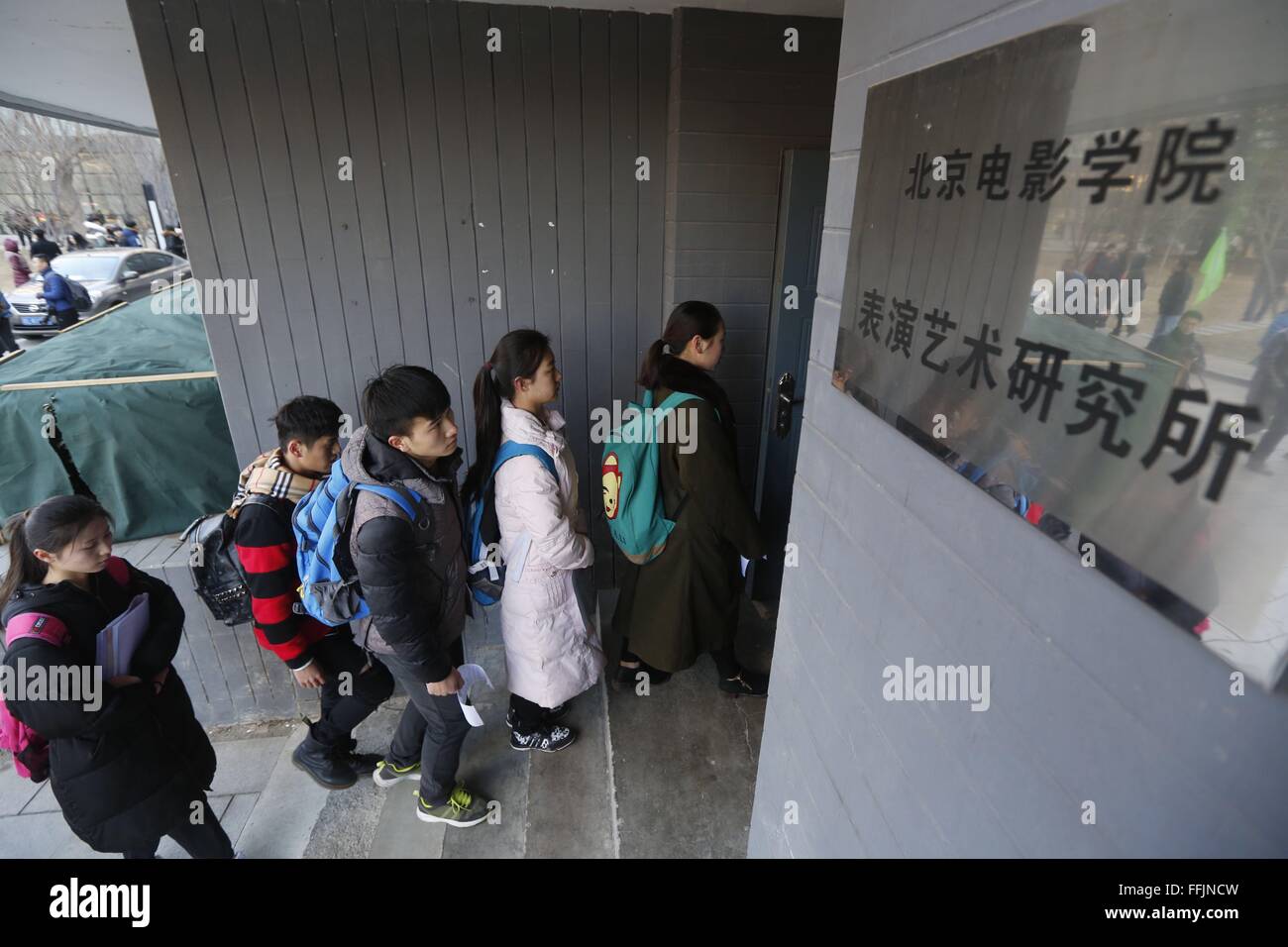 Beijing, China. 15th Feb, 2016. Candidates queue to enter the examination hall at Beijing Film Academy (BFA) in Beijing, capital of China, Feb. 15, 2016.The annual entrance exam of China's art colleges including BFA, the Central Academy of Drama and the Communication University of China started simultaneously on Monday. Over 7,600 applicants for BFA's performance institute will take part in the exam to vie for 45 vacancies in the institute. Some Chinese young people regarded studying in an art college as a shortcut to become famous in recent years. © Shen Bohan/Xinhua/Alamy Live News Stock Photo