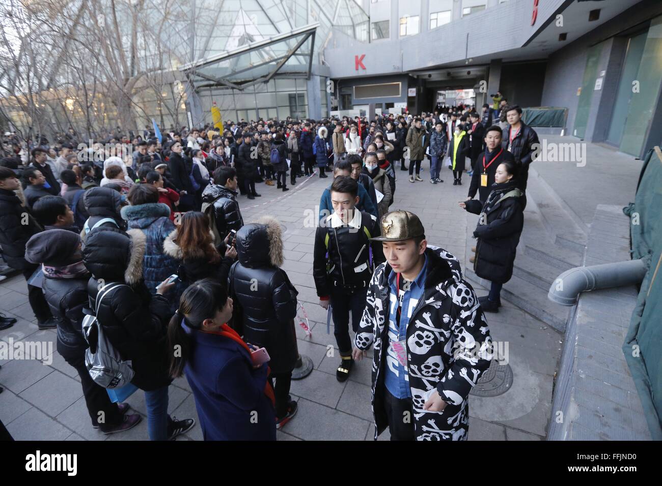 Beijing, China. 15th Feb, 2016. Candidates queue to enter the examination hall at Beijing Film Academy (BFA) in Beijing, capital of China, Feb. 15, 2016. The annual entrance exam of China's art colleges including BFA, the Central Academy of Drama and the Communication University of China started simultaneously on Monday. Over 7,600 applicants for BFA's performance institute will take part in the exam to vie for 45 vacancies in the institute. Some Chinese young people regarded studying in an art college as a shortcut to become famous in recent years. © Shen Bohan/Xinhua/Alamy Live News Stock Photo