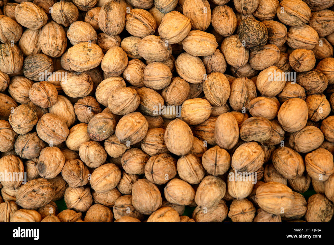 Walnuts in their shells Stock Photo Alamy