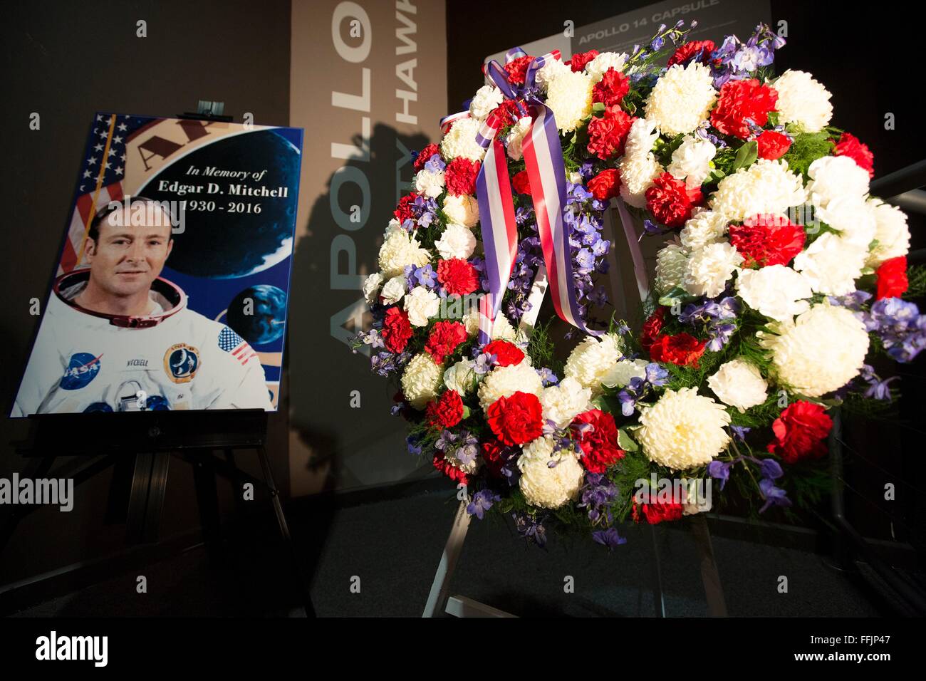 A memorial wreath placed next to the Apollo 14 command module exhibit at the Saturn V Building to honor the memory of former NASA astronaut Edgar Mitchell at the Kennedy Space Center February 12, 2016 in Cape Canaveral, Florida. Mitchell, one of 12 humans to walk on the moon died February 4, 2016. Stock Photo