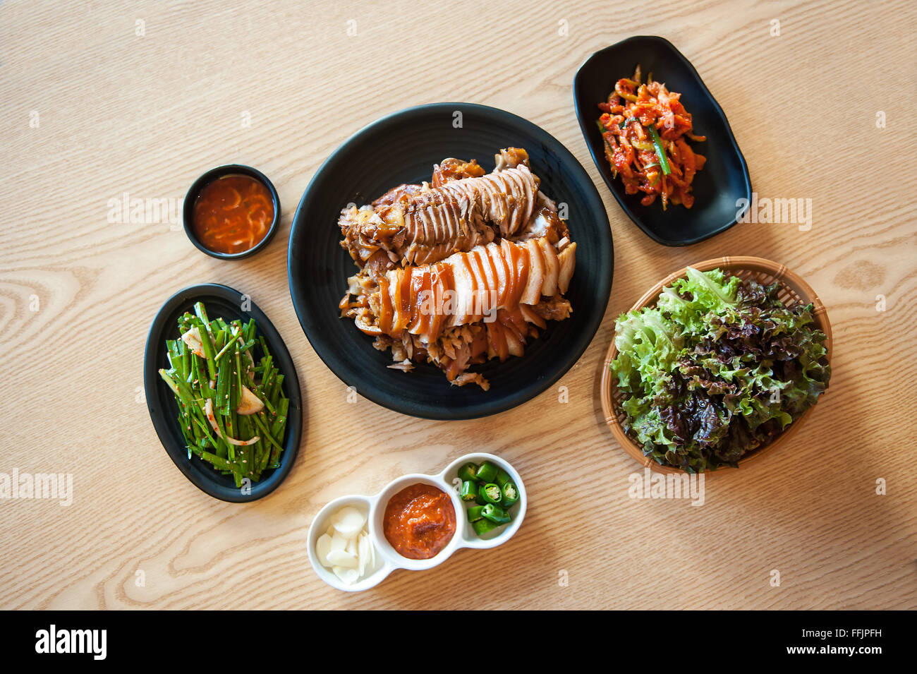 Korea Food Side Dish With Roast Pork Dishes Placed On The Table