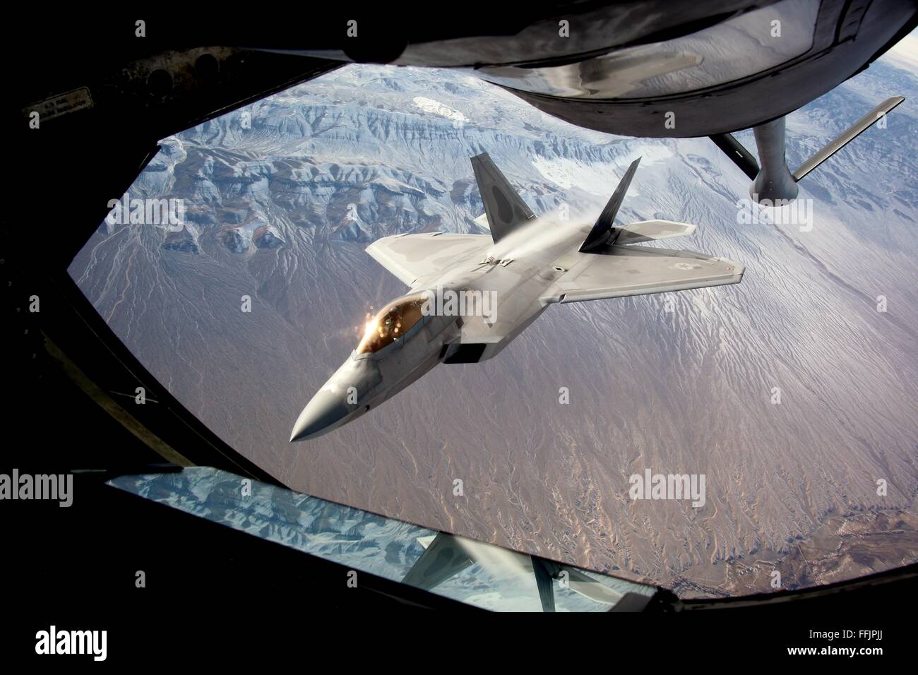 A U.S. Air Force F-22 Raptor stealth fighter aircraft refuels during exercise Red Flag February 13, 2016 over Nevada. Stock Photo