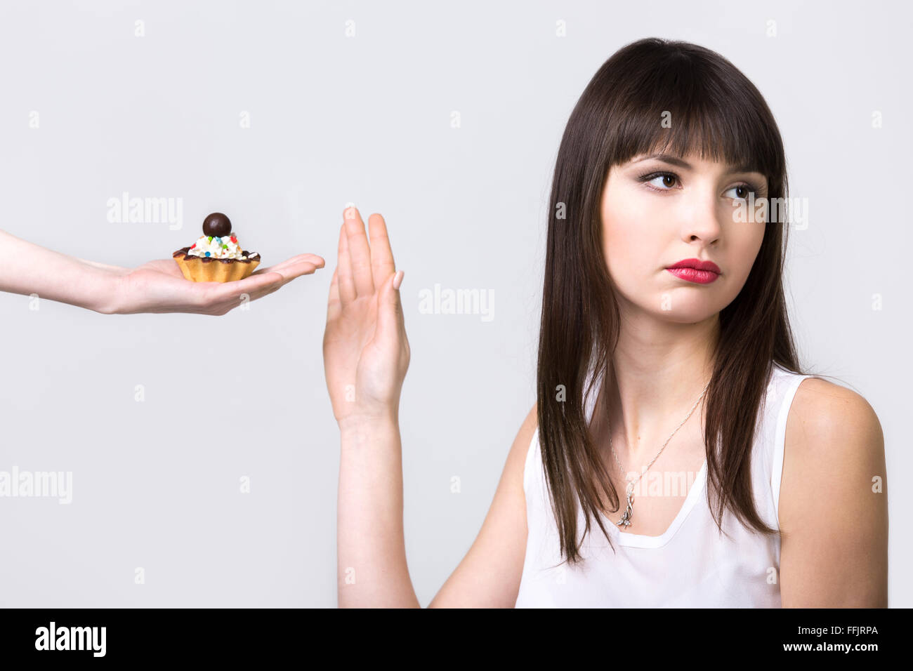 Refusing Dessert Young resolute dieting beautiful woman refusing tart cake with cream ...