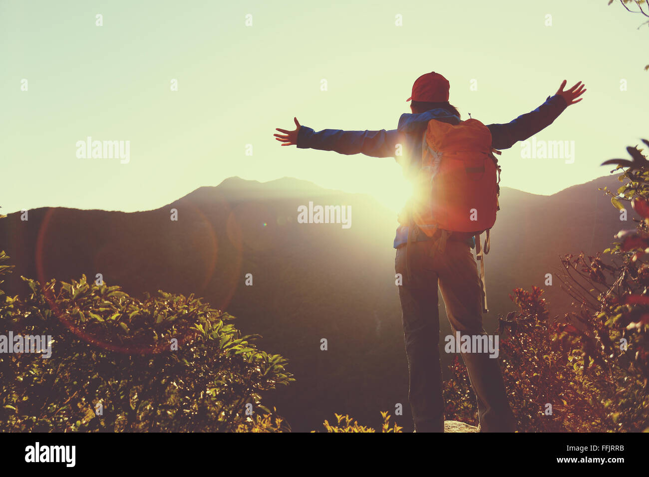 successful woman hiker open arms on sunrise mountain peak Stock Photo ...