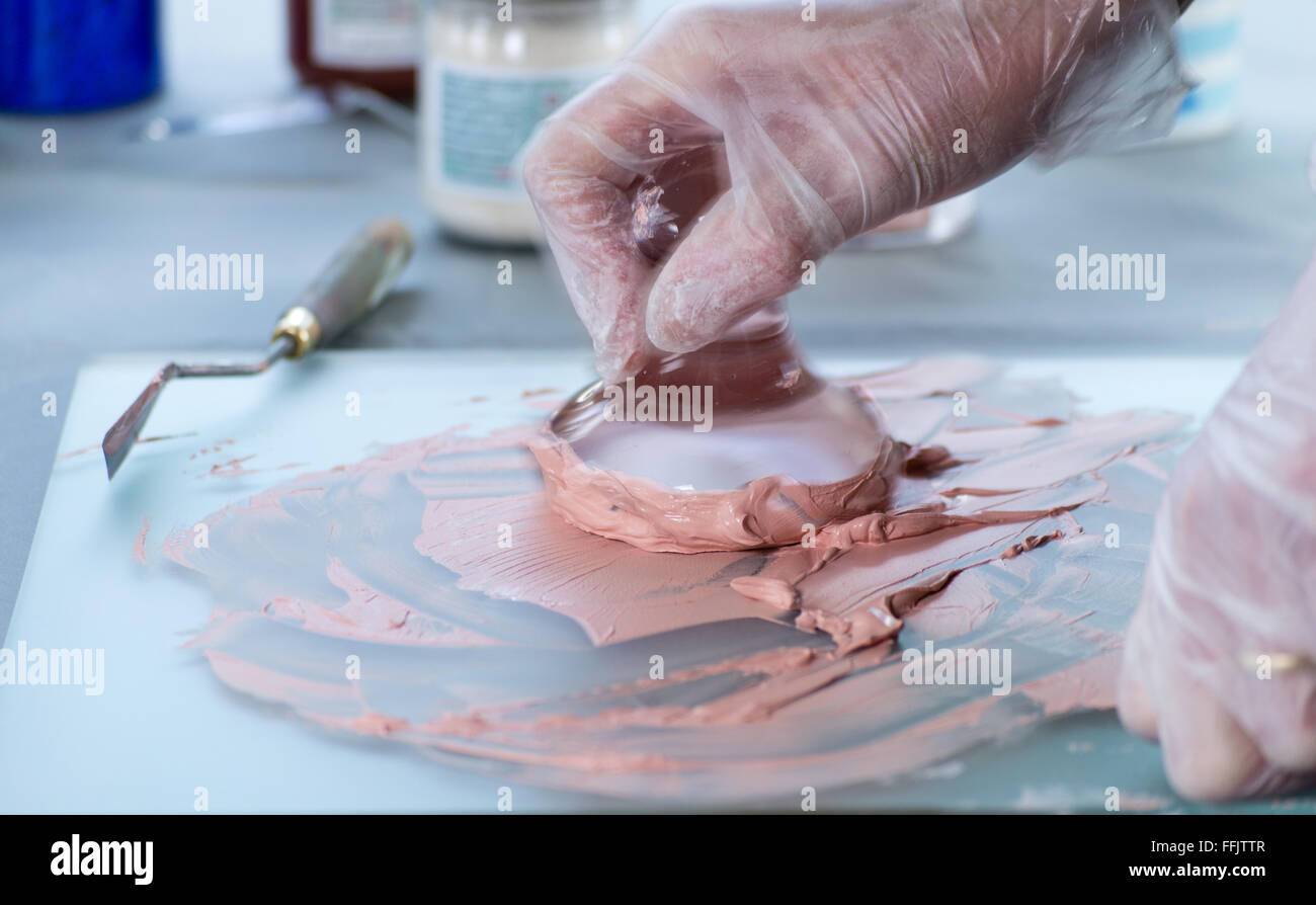 A glass muller used to grind pigment into paint Stock Photo - Alamy