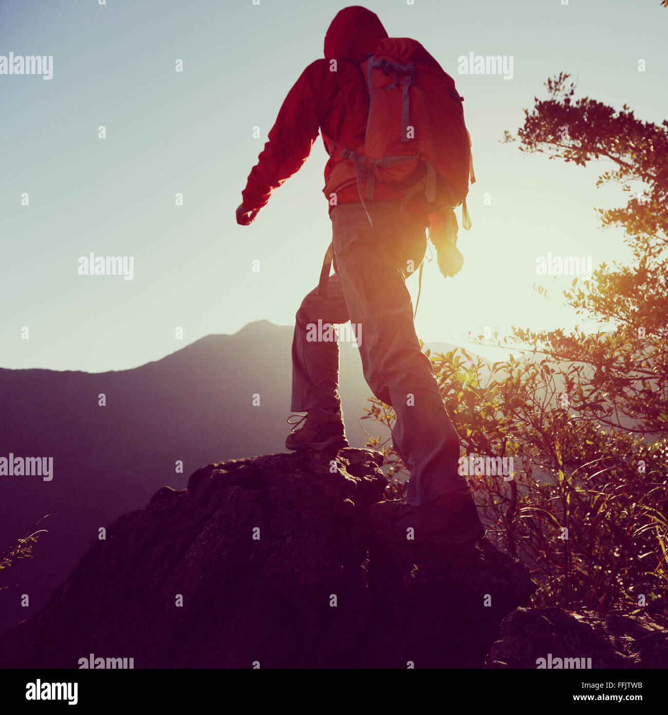 young woman hiker hiking on sunrise mountain peak Stock Photo - Alamy