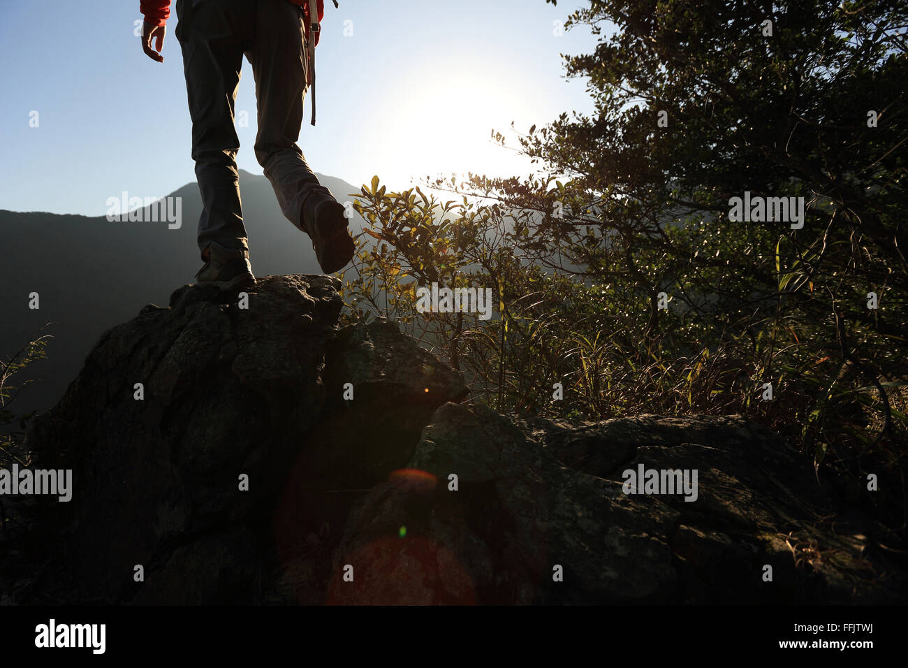 young woman hiker hiking on sunrise mountain peak Stock Photo - Alamy