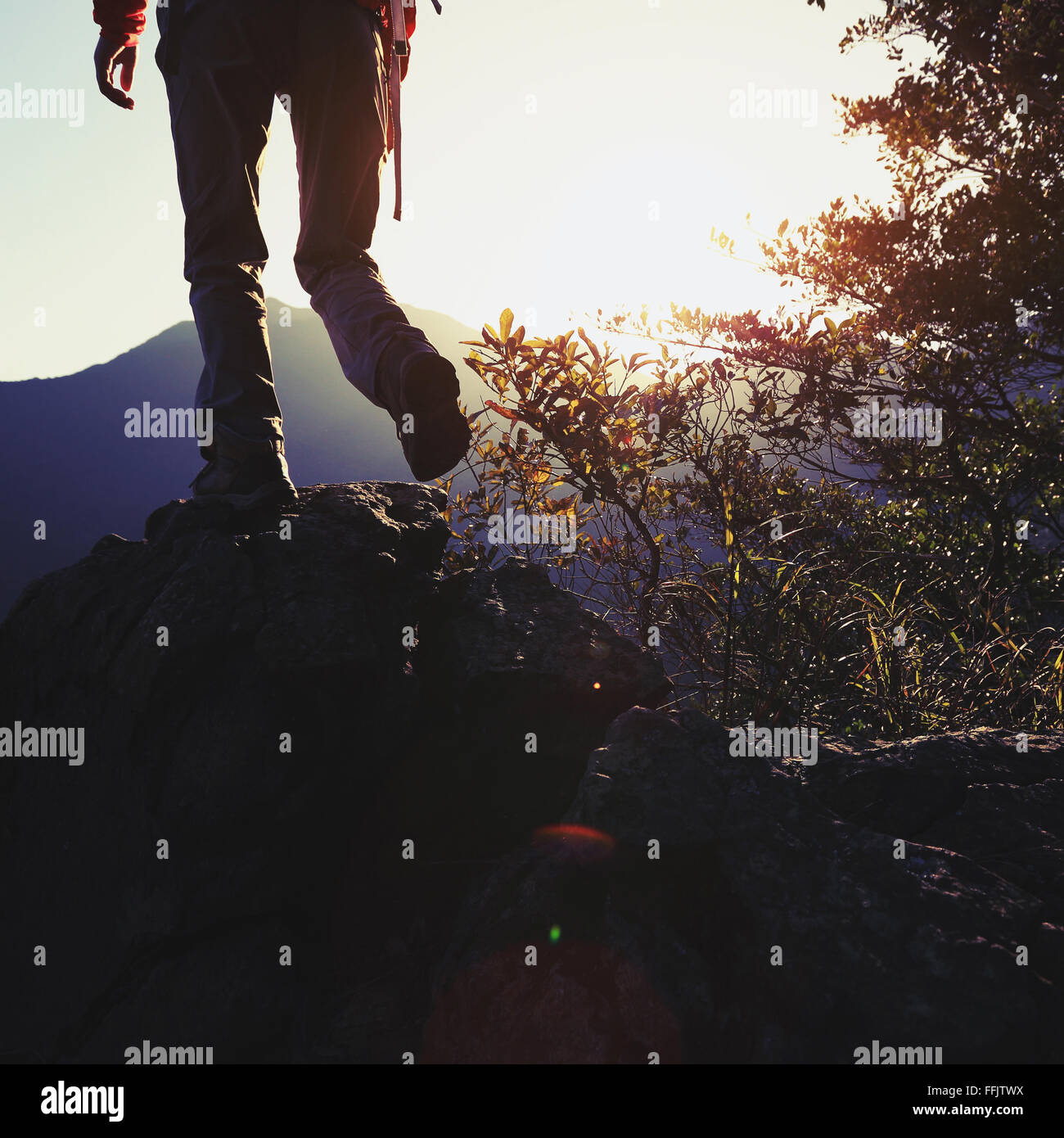 young woman hiker hiking on sunrise mountain peak Stock Photo - Alamy