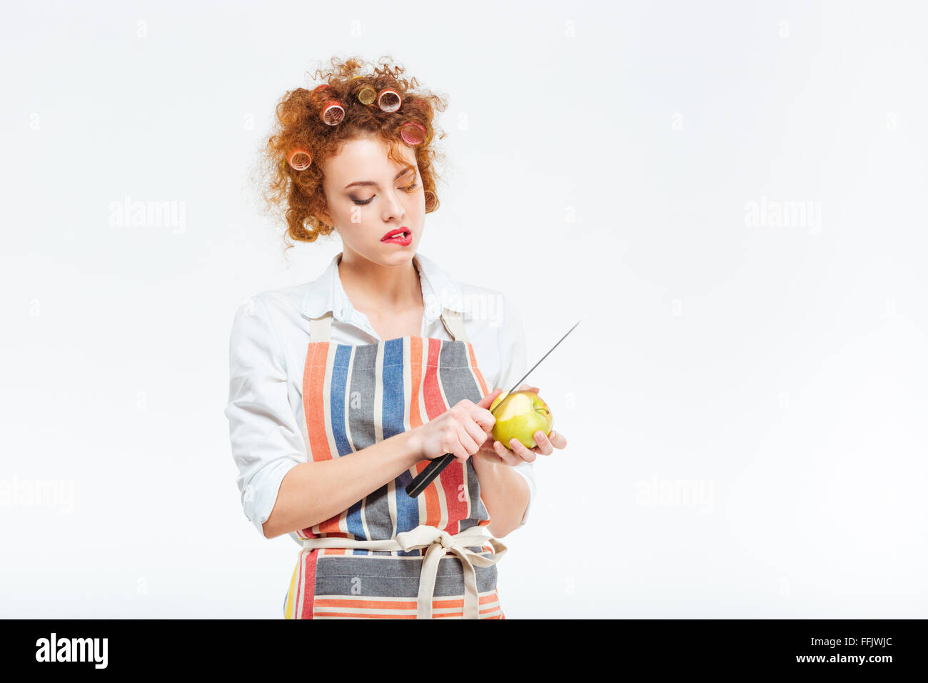 Housewife cutting apple isolated on a white background Stock Photo
