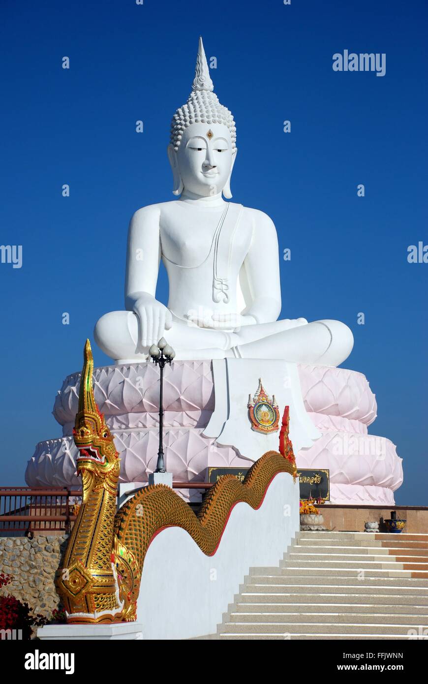 Big white buddha statue with serpent king on stairs at Pasak Jolasid Dam, Thailand Stock Photo