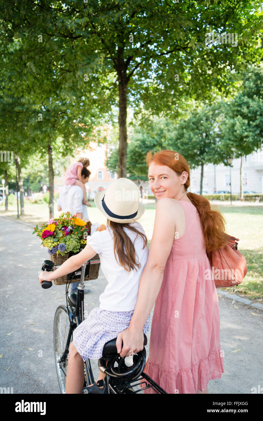 Mother and daughter riding bicycle Stock Photo