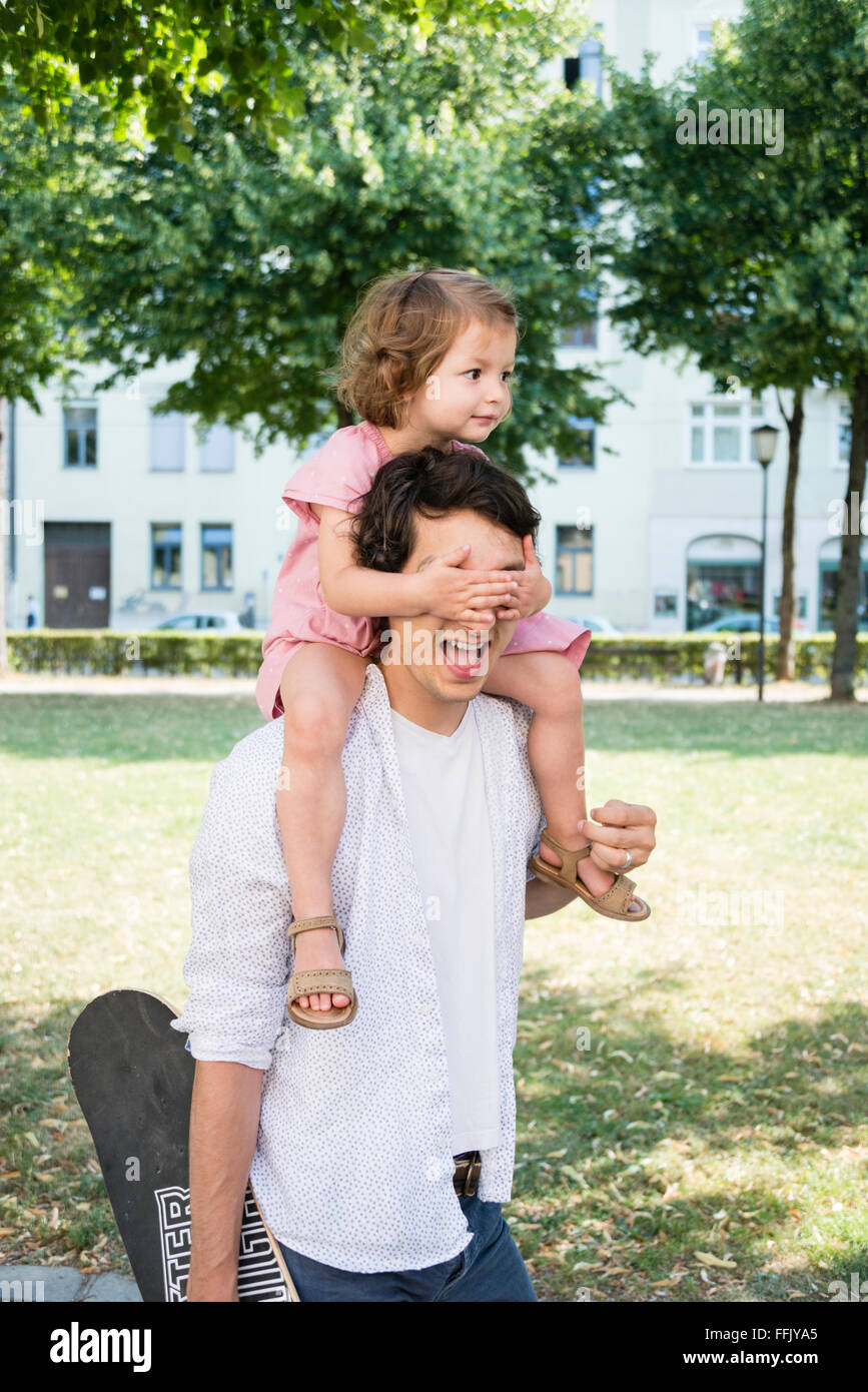 Daughter covering father's eyes Stock Photo