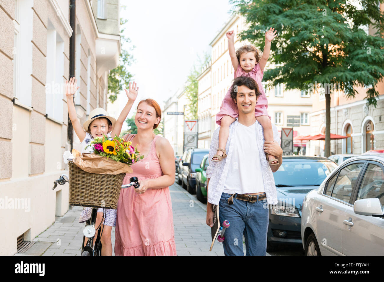 Family with two children walking in city Stock Photo