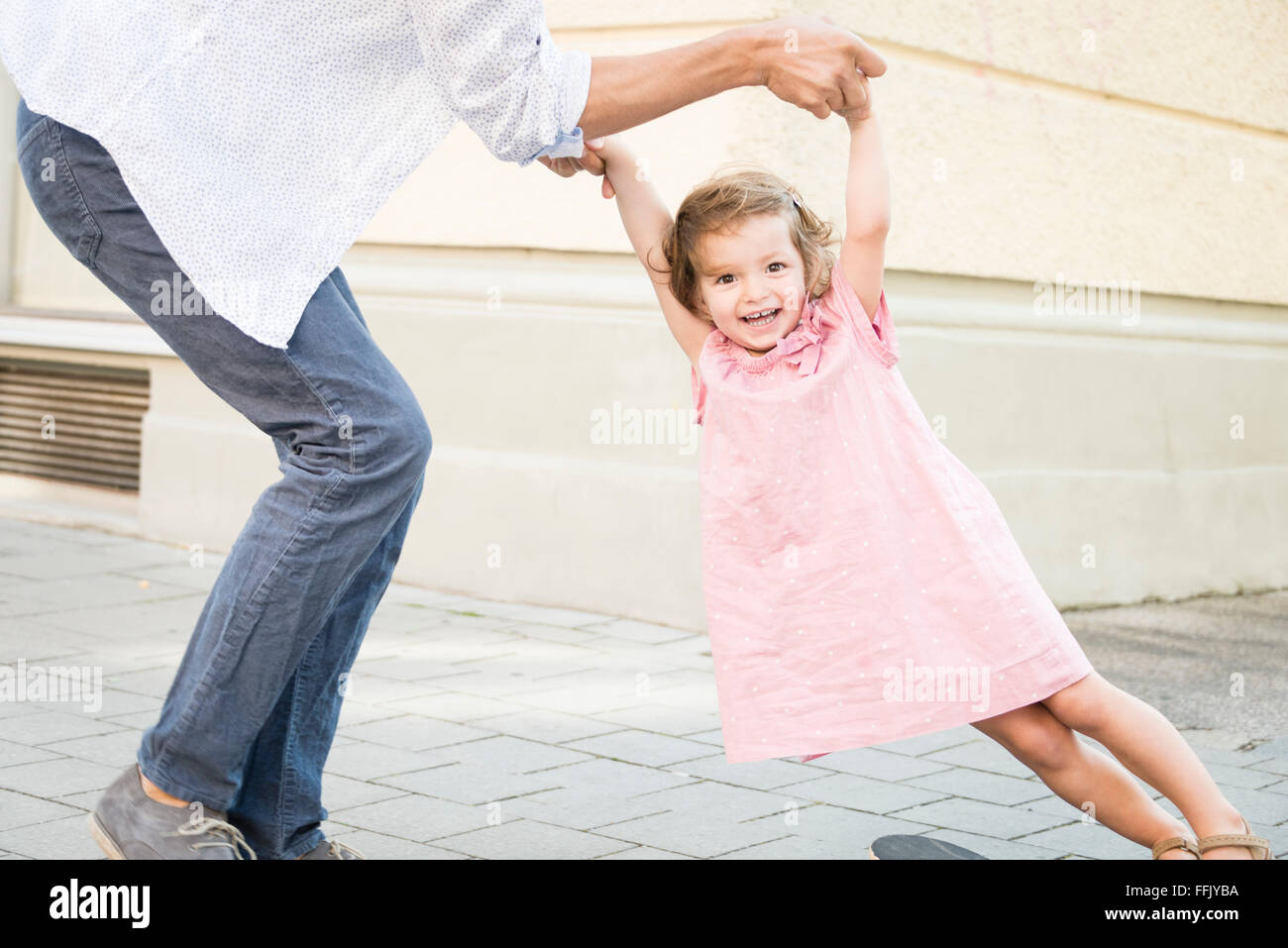 Father and daughter on skateboard Stock Photo