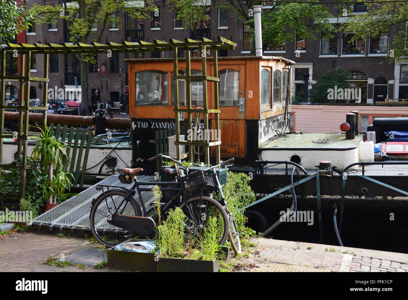 Close up of canal boat home with bicycles out front. Canal boats can be quite lavish and are a way of life in Amsterdam. Stock Photo