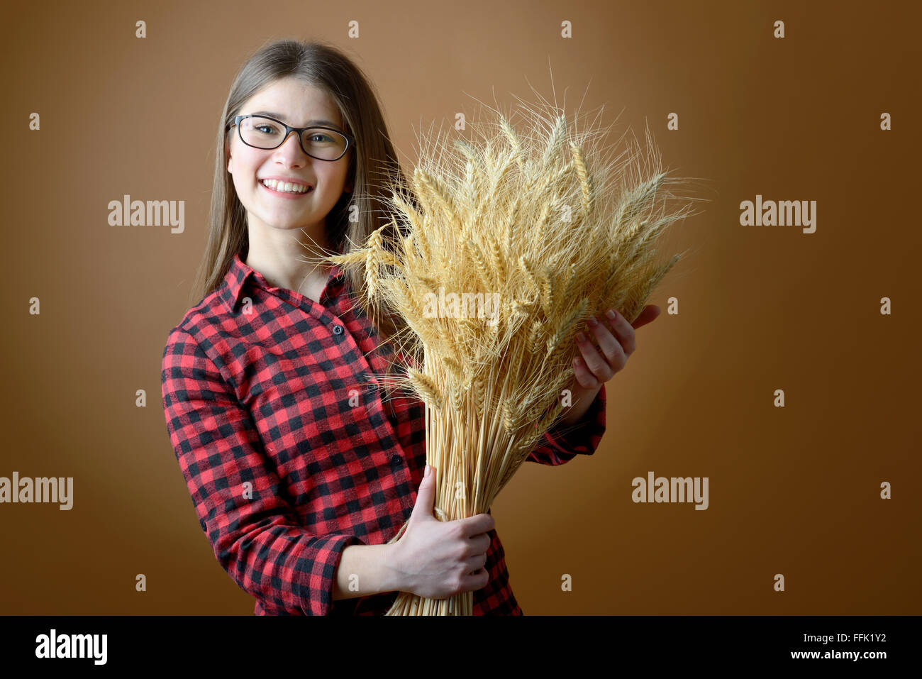 teen girl hold in hand bunch of wheat stalks Stock Photo