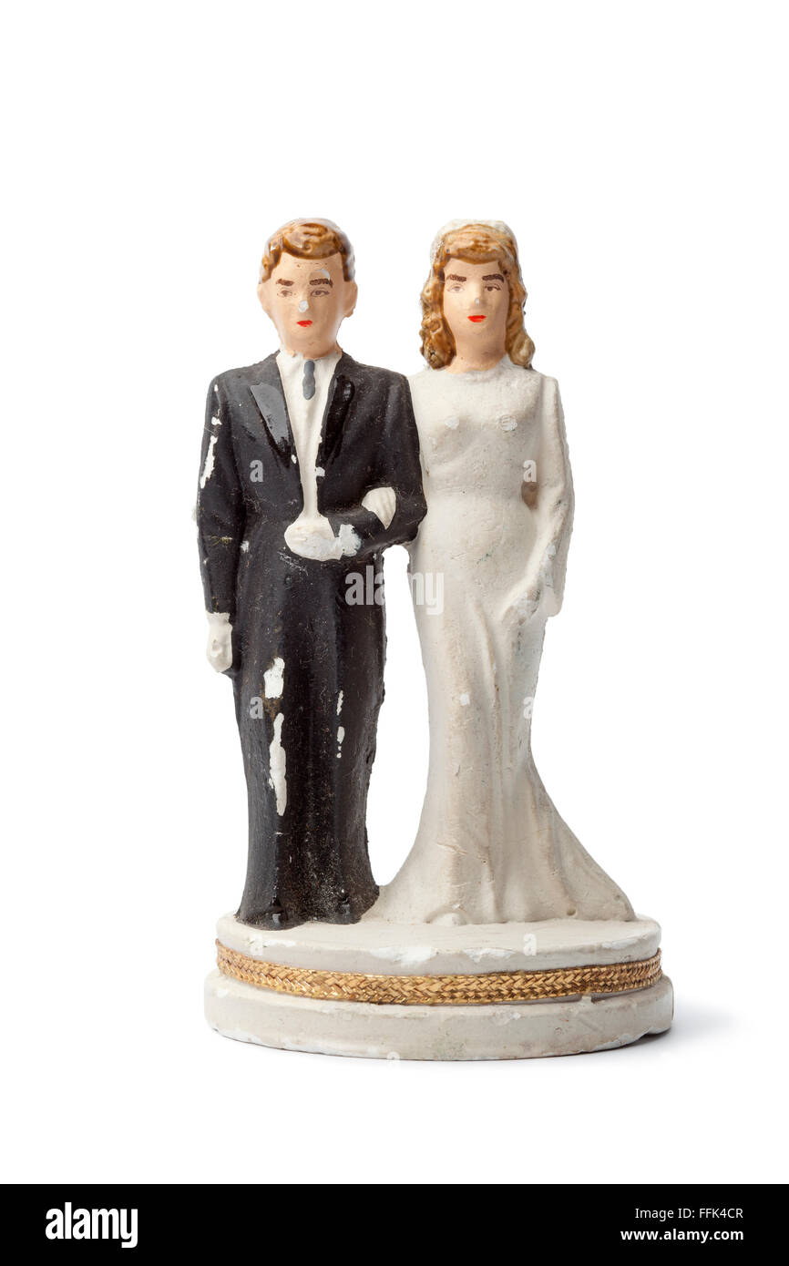 Old damaged plaster bride and groom cake topper isolated on white background Stock Photo