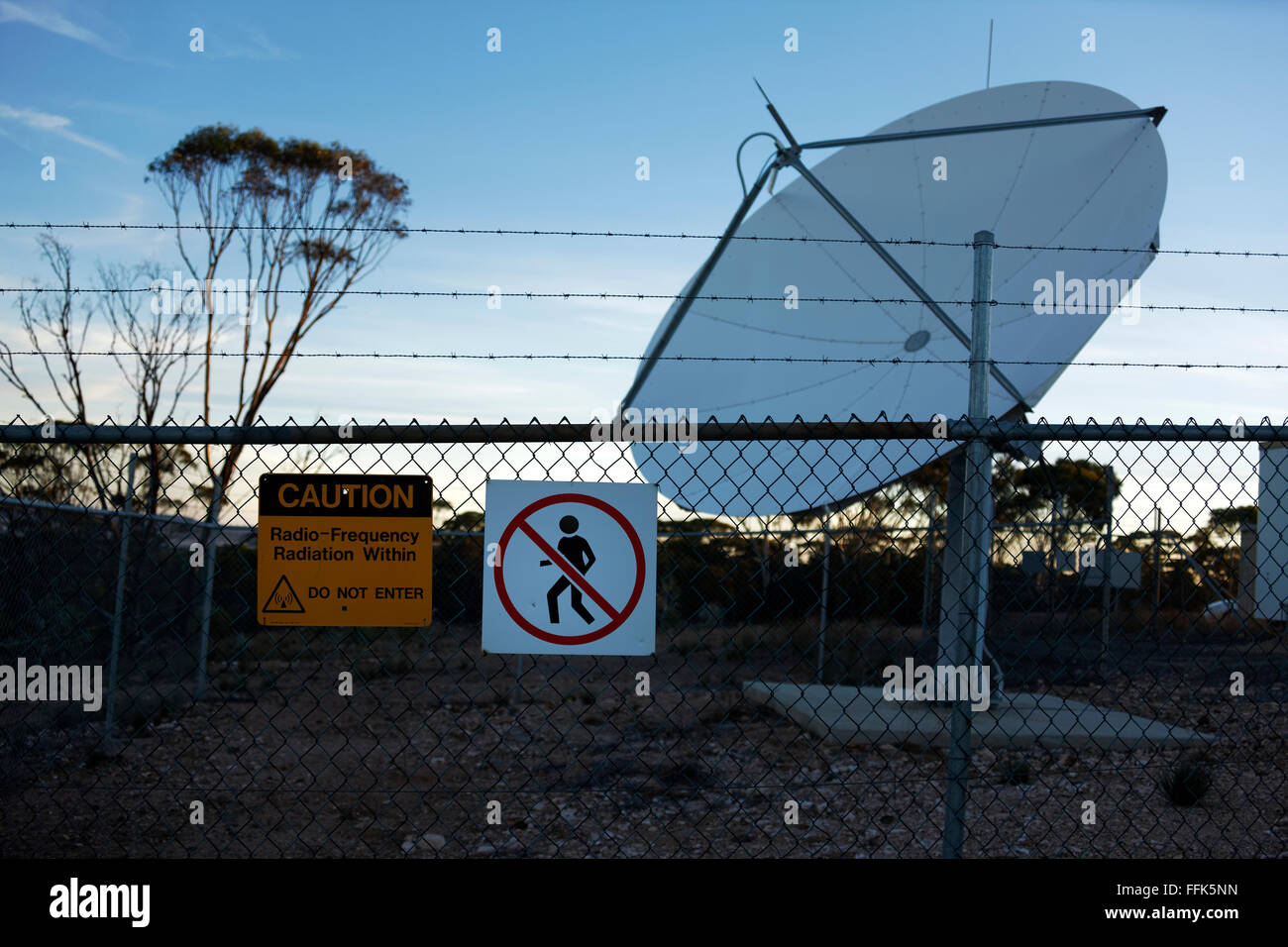 Radiation Warning Sign on fence with Satellite Dish, Norseman, Western  Australia Stock Photo - Alamy