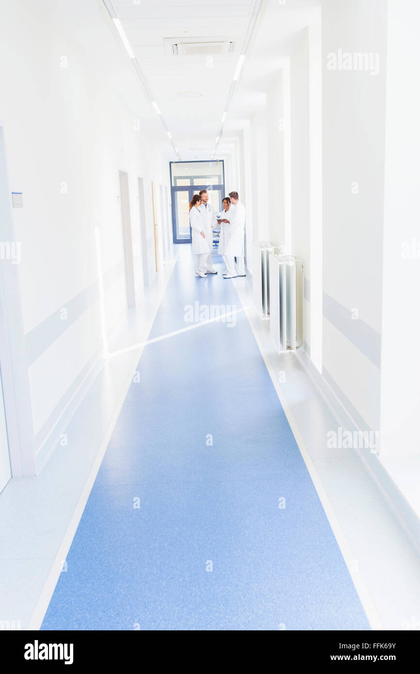 Healthcare workers standing in hospital corridor Stock Photo
