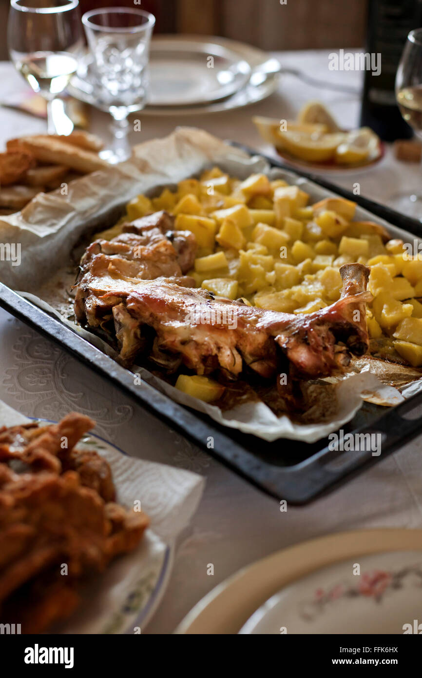 Roasted lamb and potatoes on a baking tray served for lunch Stock Photo