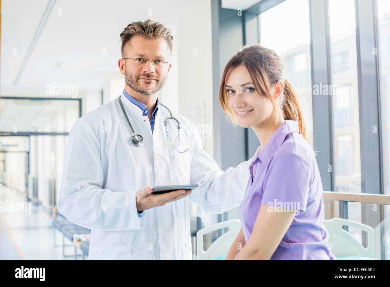 Doctor tapping coworker on the shoulder Stock Photo
