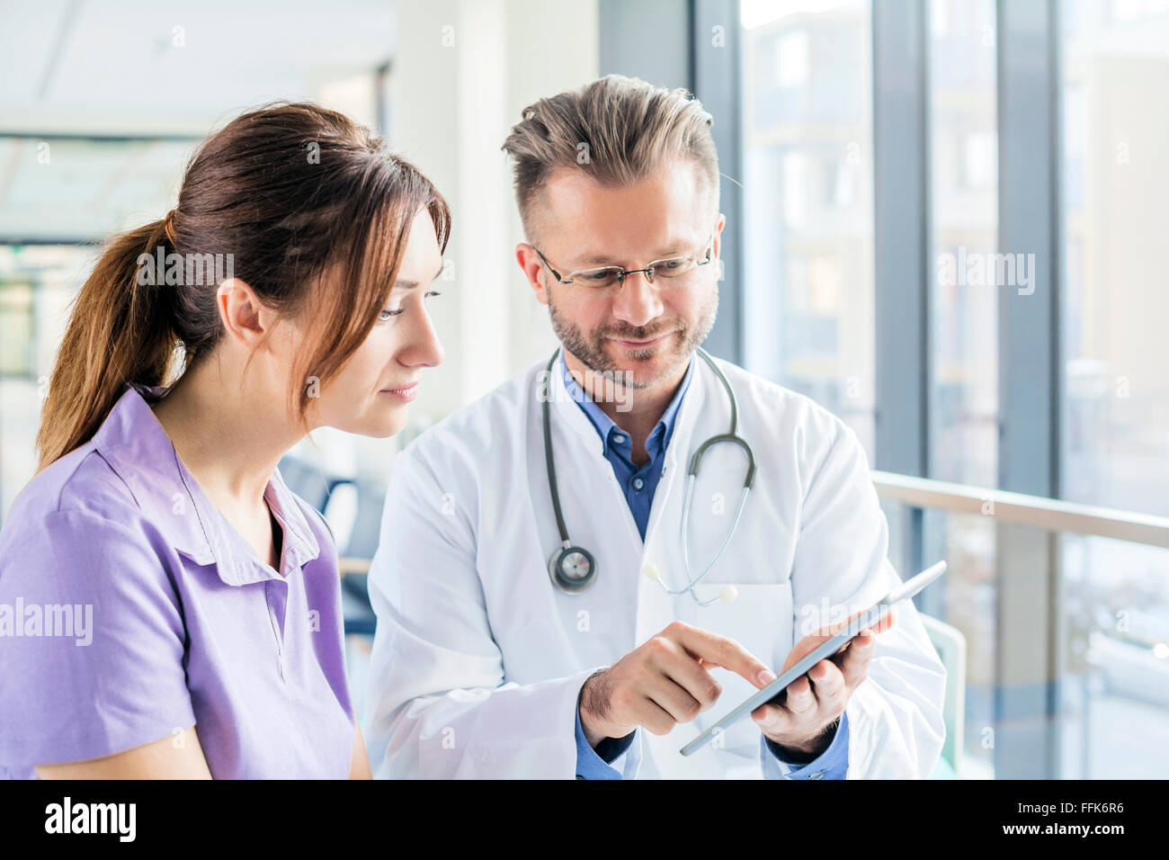 Doctor and nurse looking at digital tablet in hospital Stock Photo