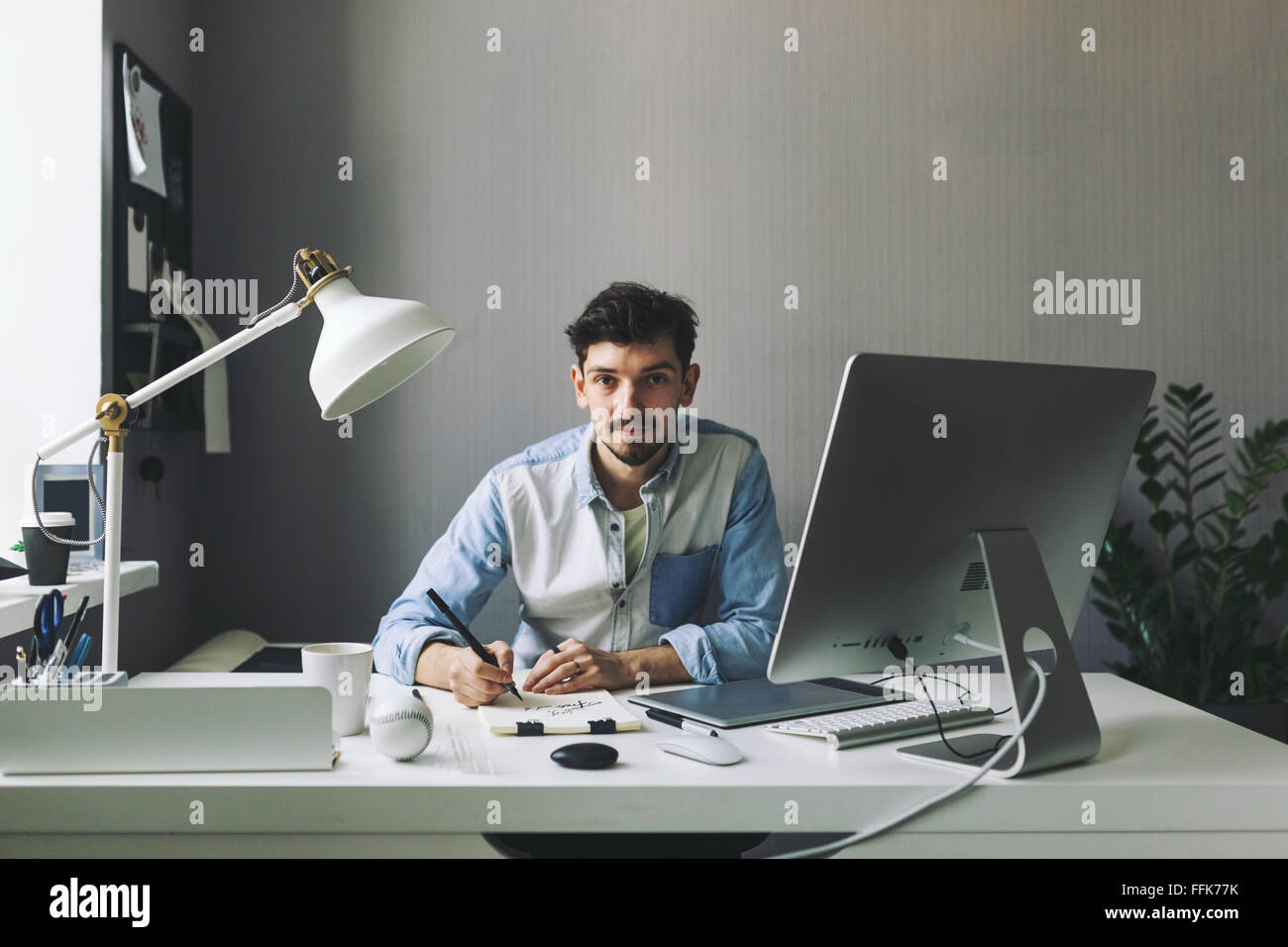Young graphic designer working in office Stock Photo
