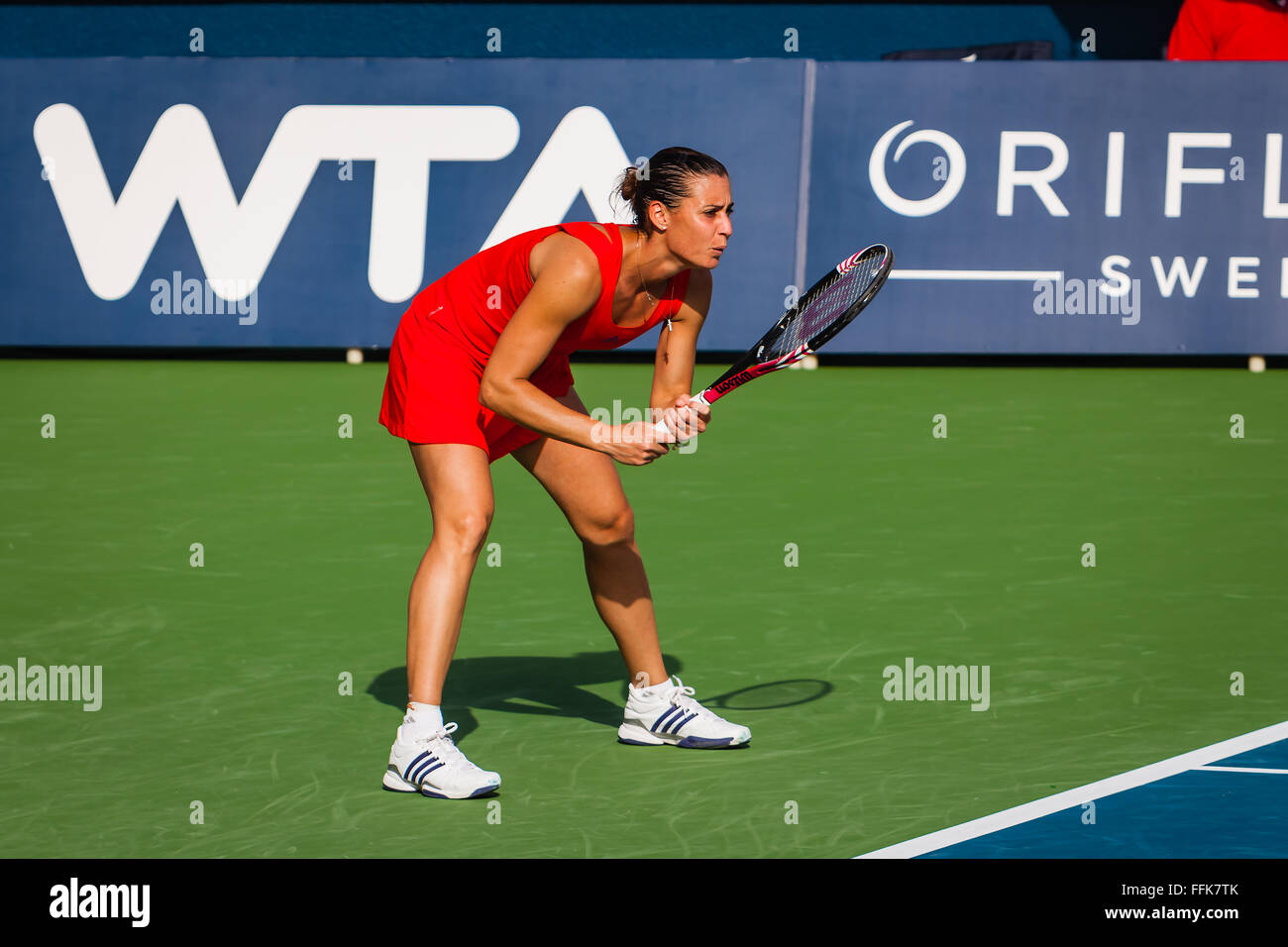 Italian Tennis Player Flavia Pennetta at the Dubai WTA Tournament 2012 stands behind the baseline, ready to receive the service of Jelena Jankovic of Serbia. She is a picture of concentration. Unfortunately she lost to Jankovic 6-2, 6-2 in this match. Pennetta later, went on to become the US Open Women's Champion in 2015.  Photo shot in the afternoon sunlight; horizontal format. Stock Photo