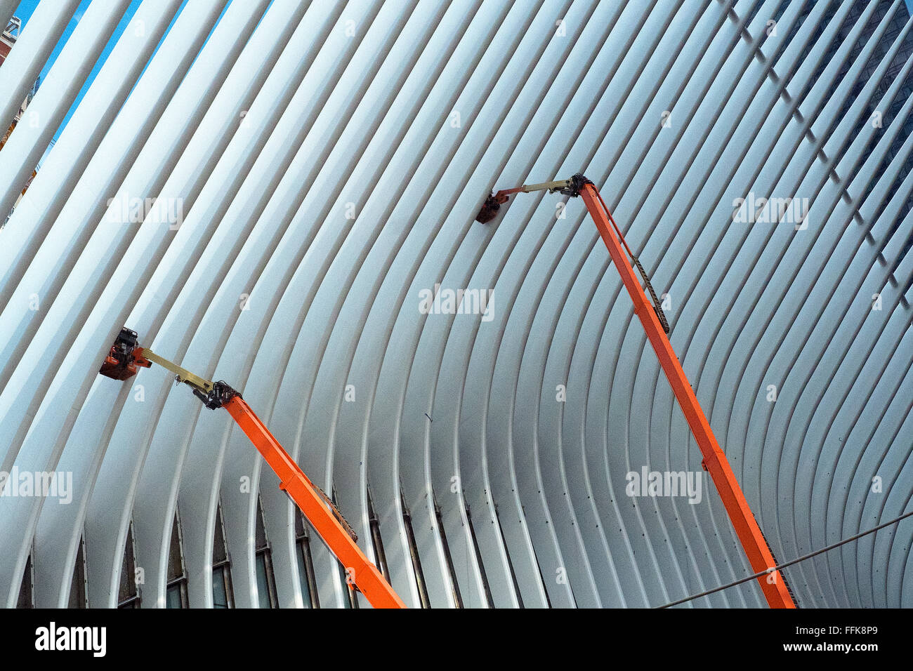 Workmen on cherry pickers paint the beams that make up the roof of the World Trade Centre Transportation Hub. Stock Photo