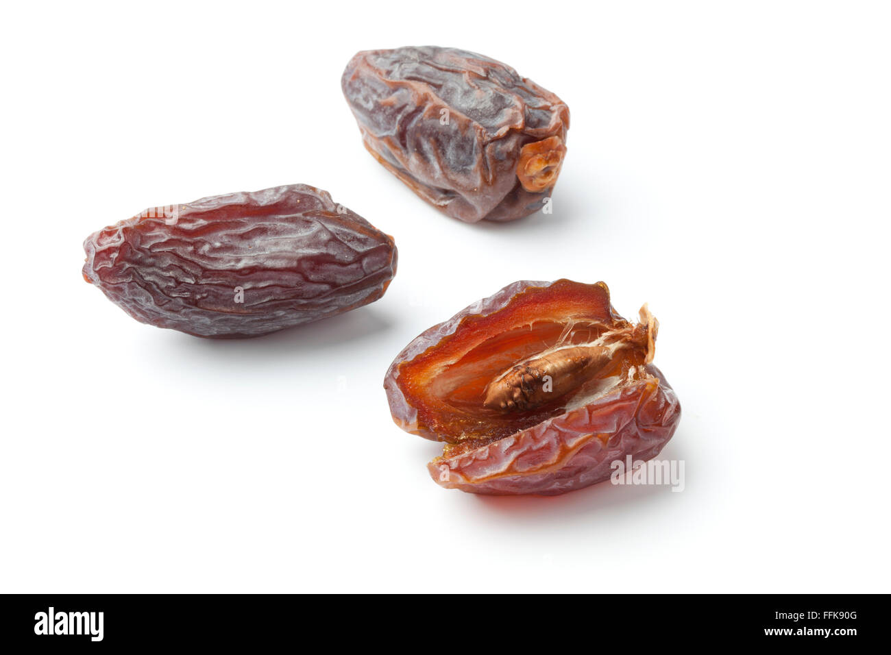 Whole and open dried dates on white background Stock Photo