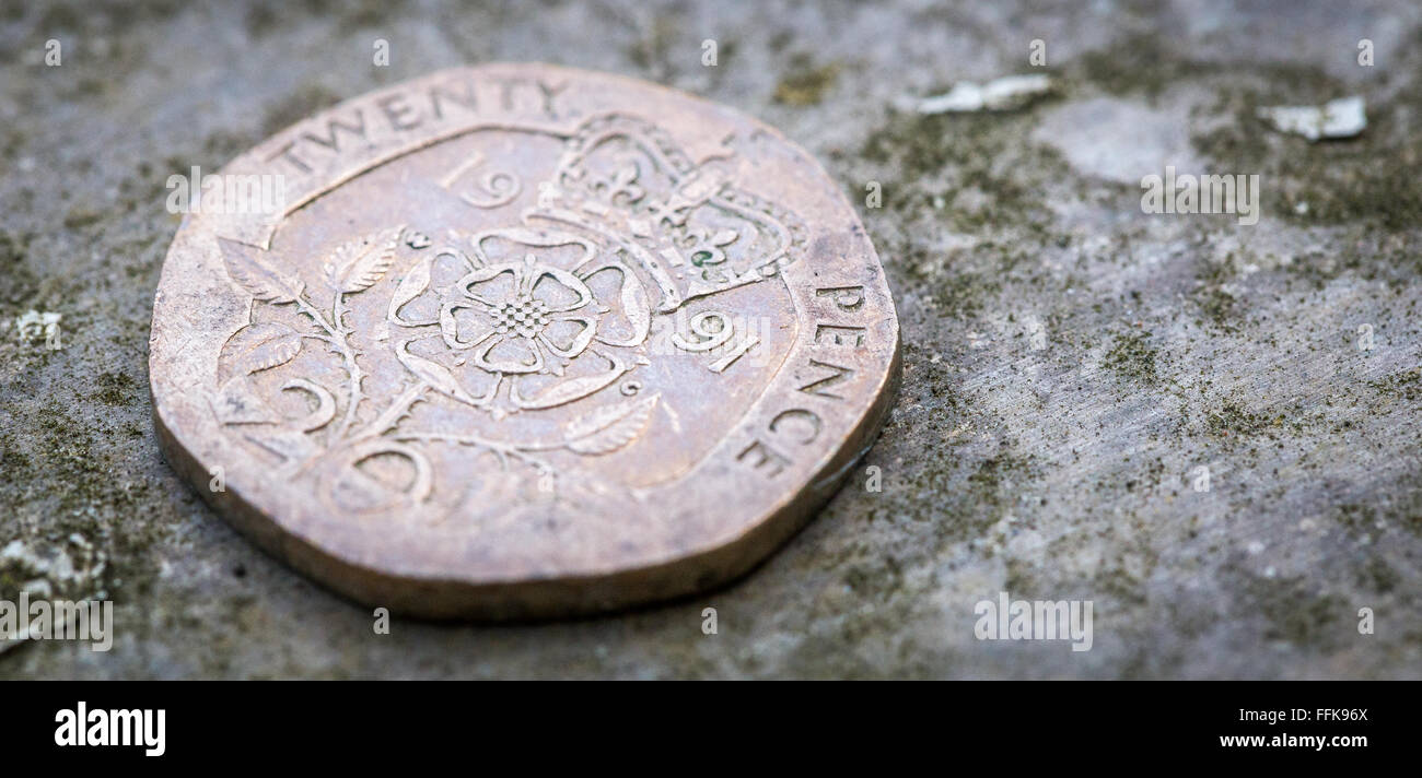 macro close up shot of 20p twenty pence on a metal shelf with green dust on a metallic background Stock Photo
