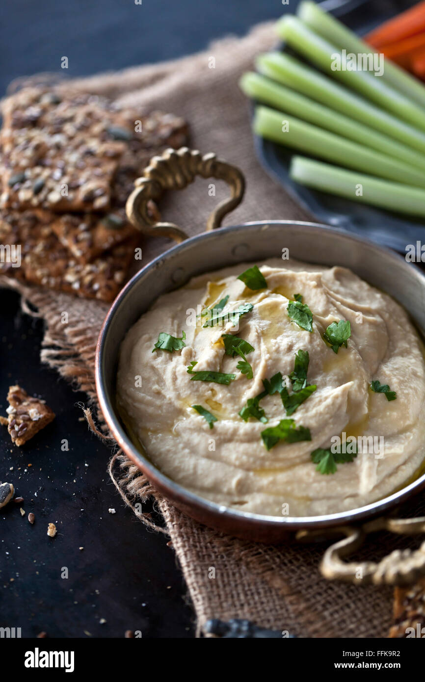 Hummus with crisp bread, carrots and celery Stock Photo Alamy