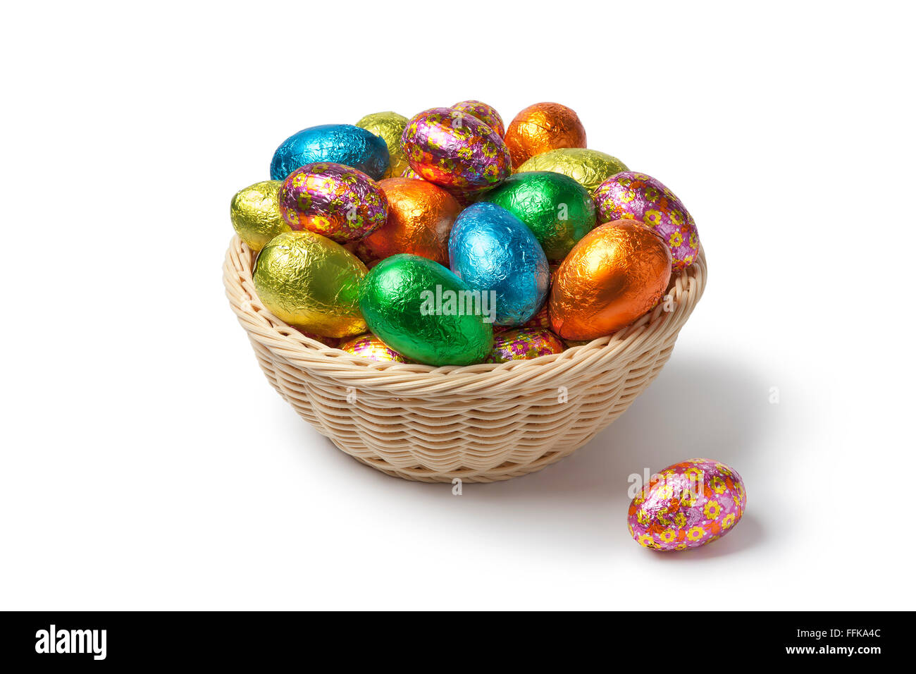 Chocolate Easter eggs in colored foil in a basket Stock Photo