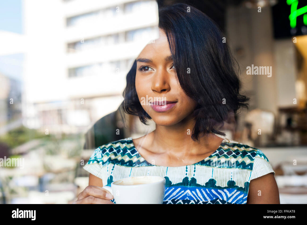 Mixed race woman takes a coffee break Stock Photo