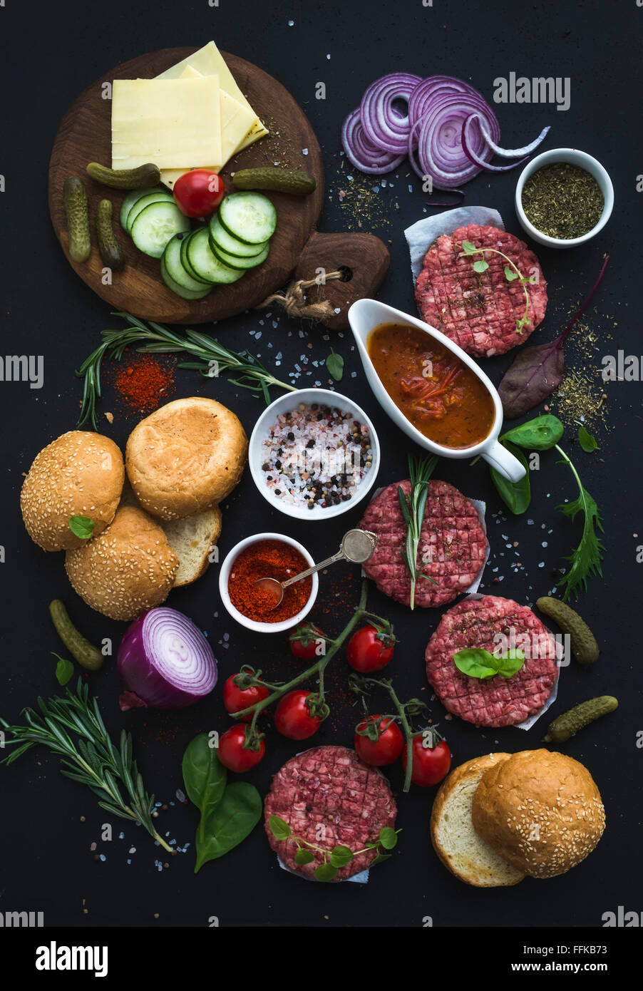 Ingredients for cooking burgers. Raw ground beef meat cutlets, buns