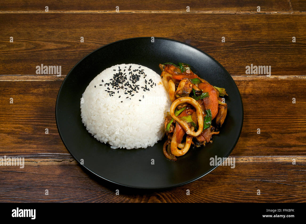 Korean dish rice with fried squid in hot sauce Stock Photo - Alamy